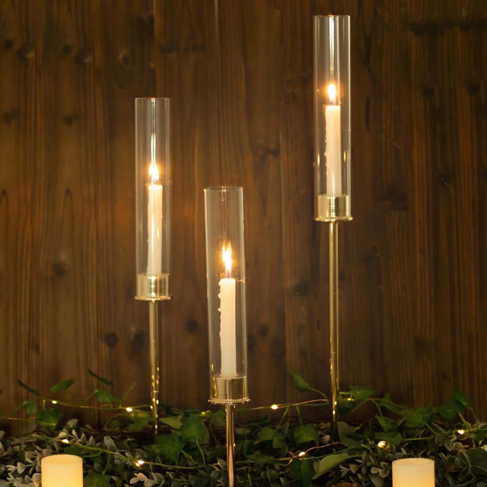 Set of 3 Tall Gold Metal Taper Candlestick Holders, Clear Glass Hurricane Candle Stands With Chimney Candle Shades 16", 20", 24"